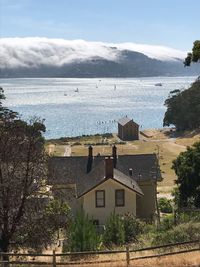 High angle view of buildings and sea against sky