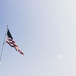 Low angle view of american flag against clear sky