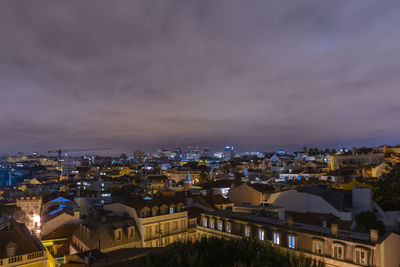 High angle view of illuminated buildings against sky at night