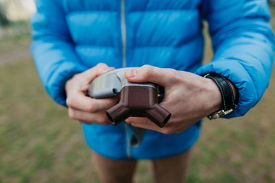 Midsection of man using mobile phone