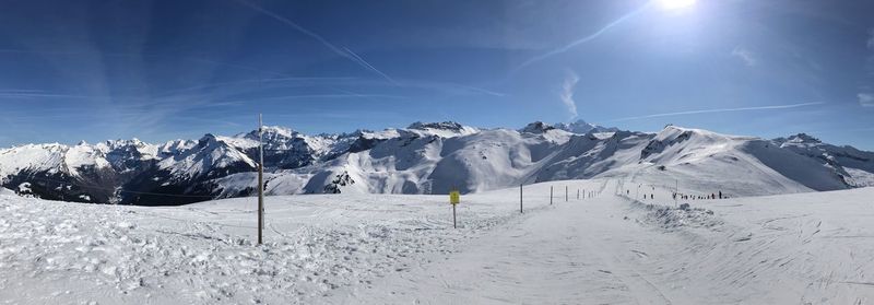 Scenic view of snow covered mountains against sky