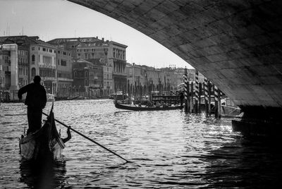 Man sailing gondola on canal