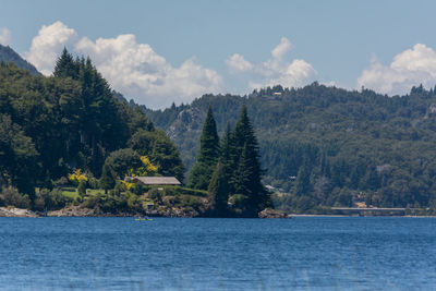 Scenic view of sea and mountains against sky