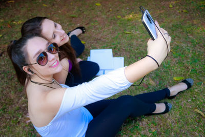 Young woman photographing with mobile phone