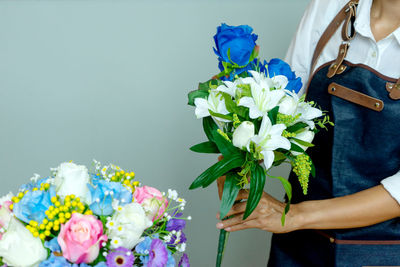 Woman holding bouquet of flowering plant