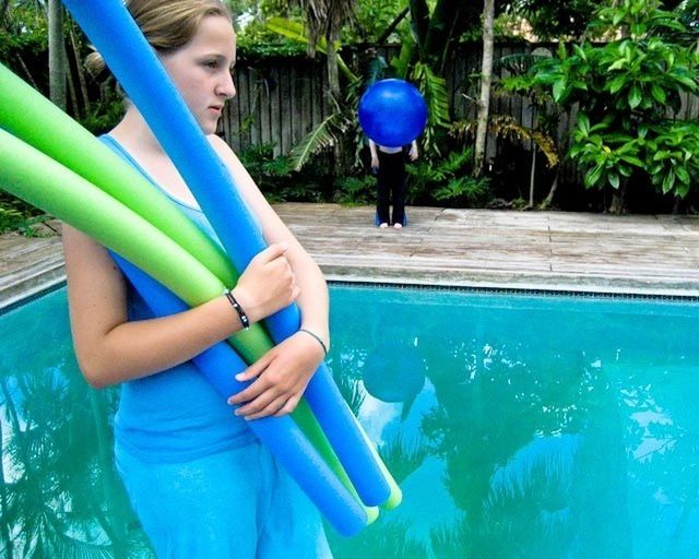 lifestyles, leisure activity, childhood, blue, fun, enjoyment, elementary age, person, casual clothing, full length, holding, girls, swimming pool, boys, playing, green color, young adult, happiness