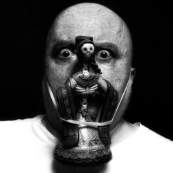 Portrait of man against black background