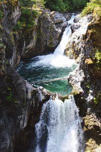 Idyllic view of waterfall in forest