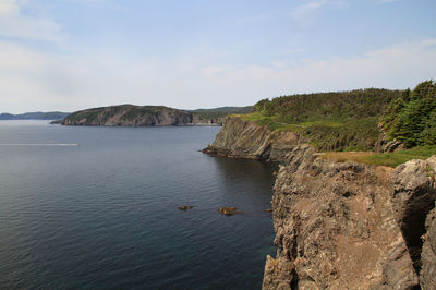 Scenic view of sea and mountains against sky