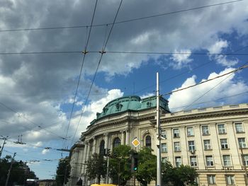 Low angle view of building against cloudy sky