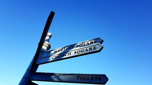 Low angle view of road sign against clear sky