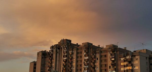 Low angle view of buildings against sky during sunset