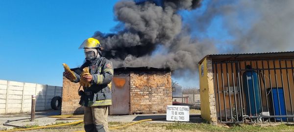 Firefighter infront of burning building