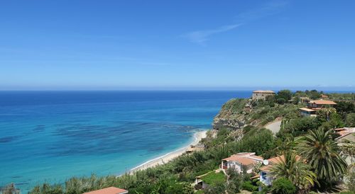 Scenic view of sea against clear blue sky