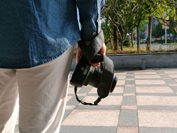 Low section of man walking on footpath