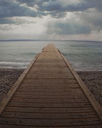 Pier over sea against sky