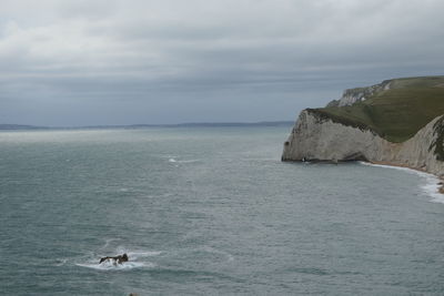 Scenic view of sea against cloudy sky