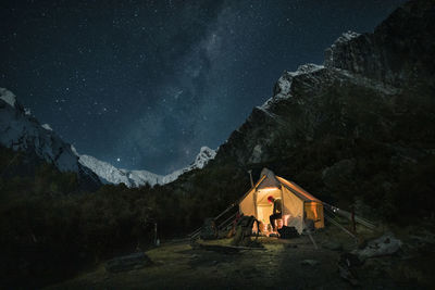 Hunter sitting in tent at night