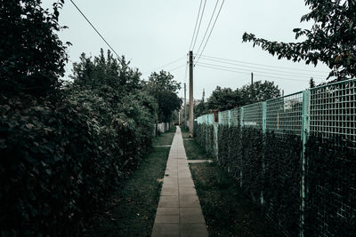 Surface level of empty road against clear sky