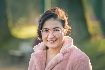 Portrait of smiling young woman standing outdoors