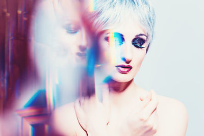 Multiple image of shirtless young woman against white background