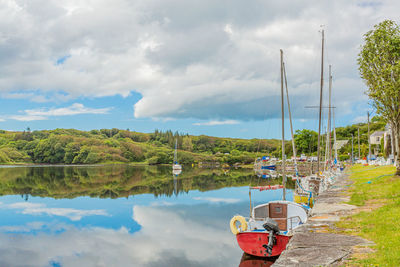 Scenic view of clifden bay at high tide against blue sky, sailing boats anchored in the harbour