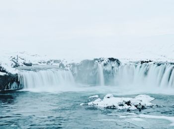 Scenic view of waterfall against clear sky