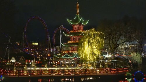 Illuminated ferris wheel at night