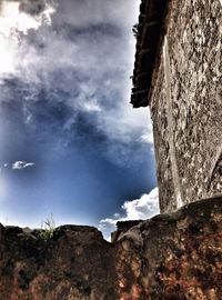 Low angle view of building against cloudy sky