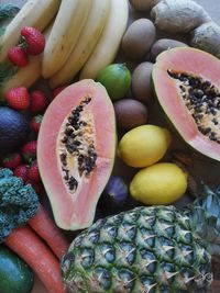 Full frame shot of fruit, kiwi, lemon, papaya, carrot 