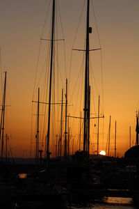 Sailboats in marina at sunset