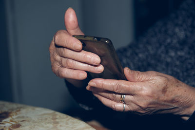 Midsection of man using mobile phone