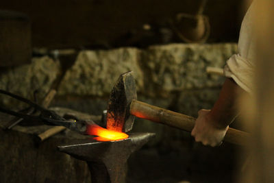 Cropped hand of carving making metal