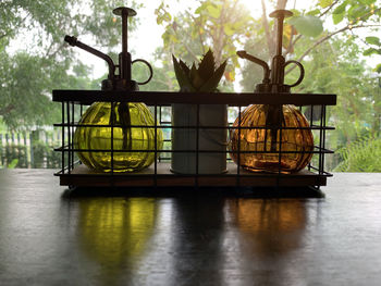 Close-up of glass jars and succulent plant on table