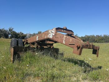 Abandoned built structure on field against clear sky