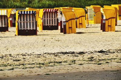 Row of hooded chairs at beach
