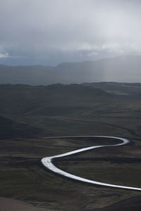 Empty road meandering through dramatic landscape in north iceland