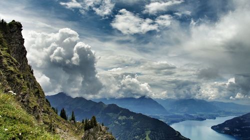 Scenic view of mountains against cloudy sky