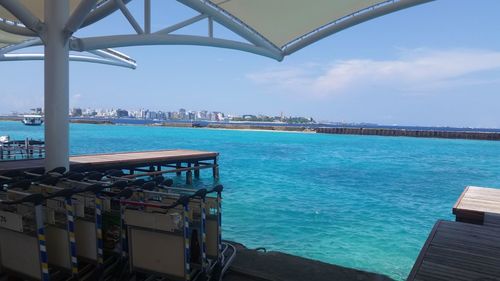 Modern city by sea against sky