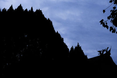 Low angle view of silhouette building against sky