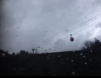 Low angle view of electricity pylon against sky