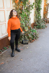 Portrait of young woman standing on street