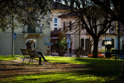 Man sitting on bench in park