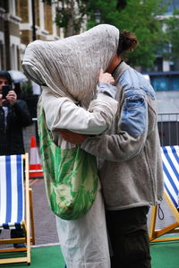 Rear view of man and woman standing on street