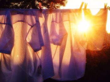 Close-up of clothes drying at sunset