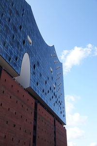 Low angle view of building against cloudy sky