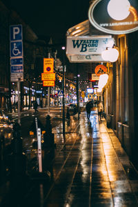Information sign in illuminated city at night