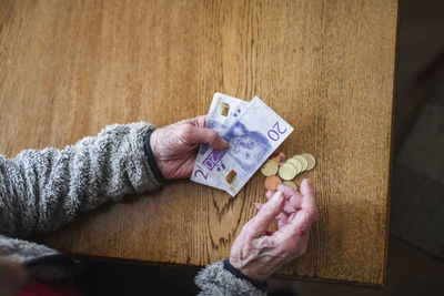 Hands holding banknotes and coins