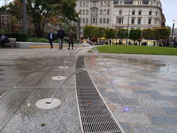 People standing on footpath in city
