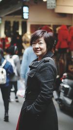 Smiling young woman standing outdoors